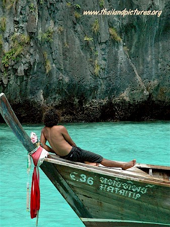 A Thai guide or fisherman just resting on his boat.