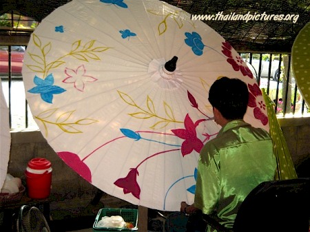 A Thai girl painting a parasol