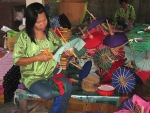 A thai girl making small umbrellas